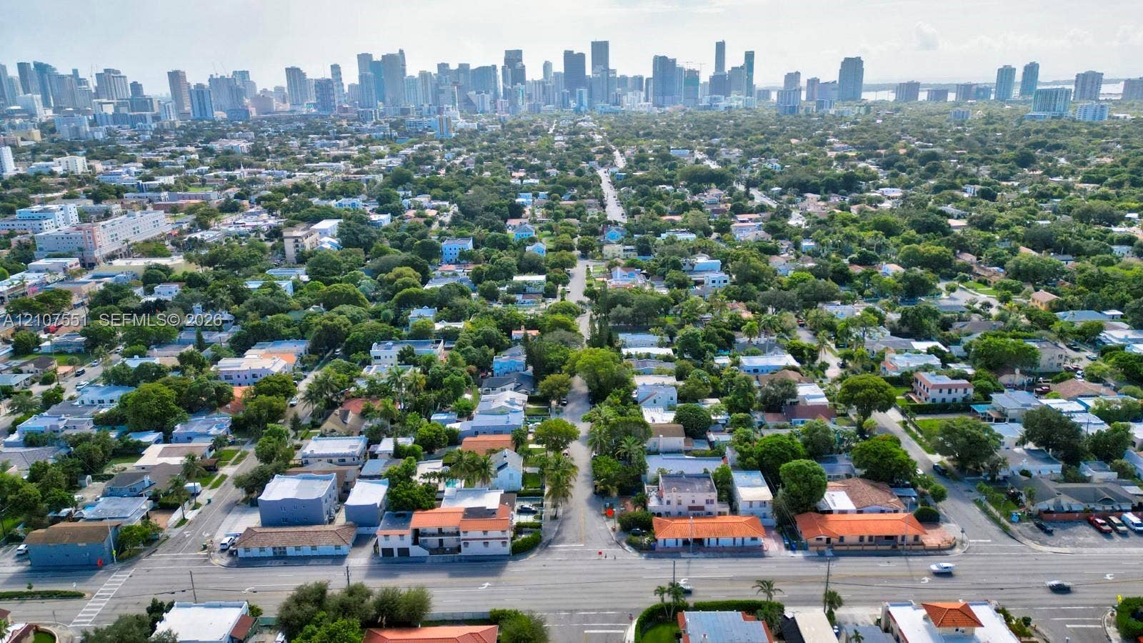 1676 SW 11th Street, Miami, Miami, FL 33135 Aerial perspective featuring dense urban canopy and prominent metropolitan skyline
