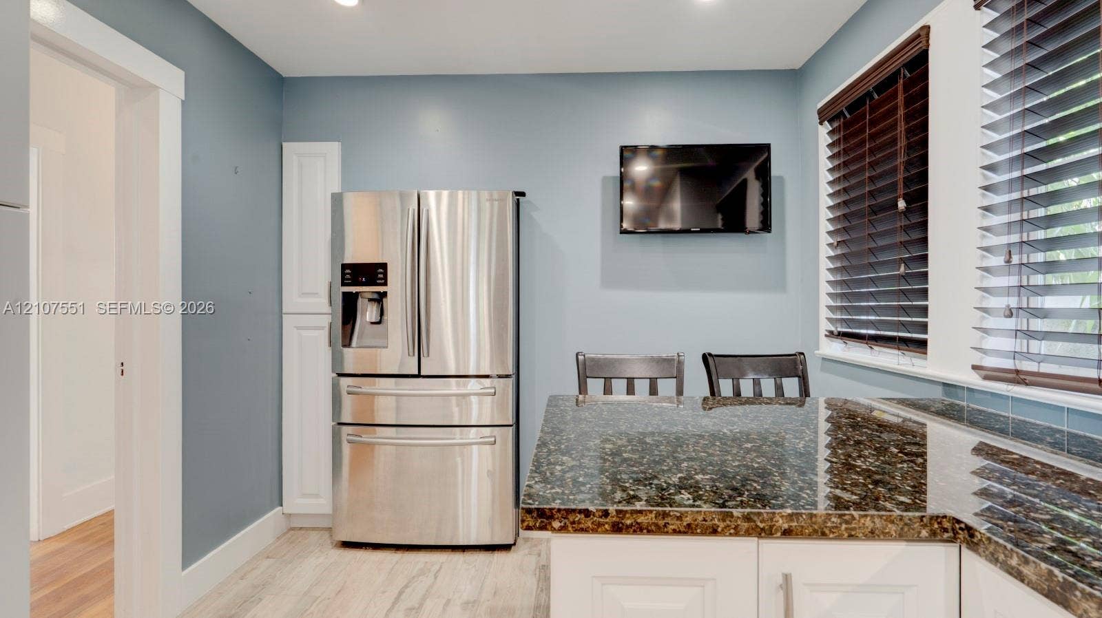 1676 SW 11th Street, Miami, Miami, FL 33135 Kitchen featuring stone countertops, white shaker-style cabinetry, stainless steel French-door refrigerator, wood-finish flooring, and horizontal window blinds
