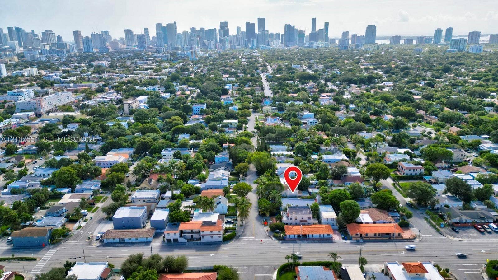 1676 SW 11th Street, Miami, Miami, FL 33135 Aerial perspective featuring an urban skyline backdrop, mature canopy trees, and established neighborhood infrastructure