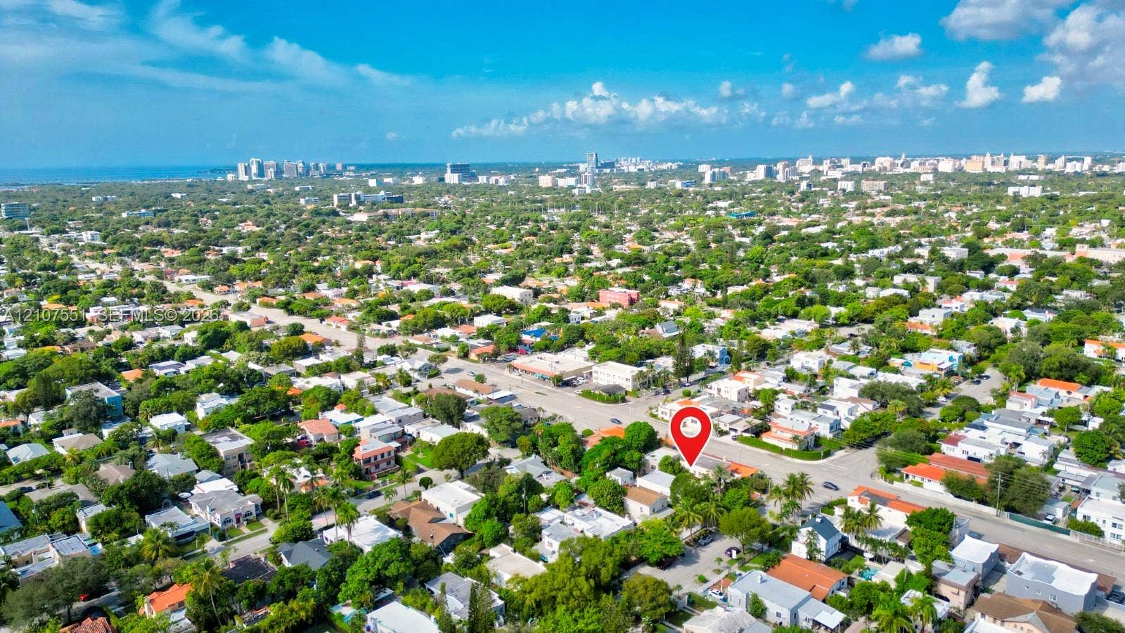 1676 SW 11th Street, Miami, Miami, FL 33135 Aerial perspective highlighting a residential location featuring mature trees, surrounding foliage, and proximity to the coastline