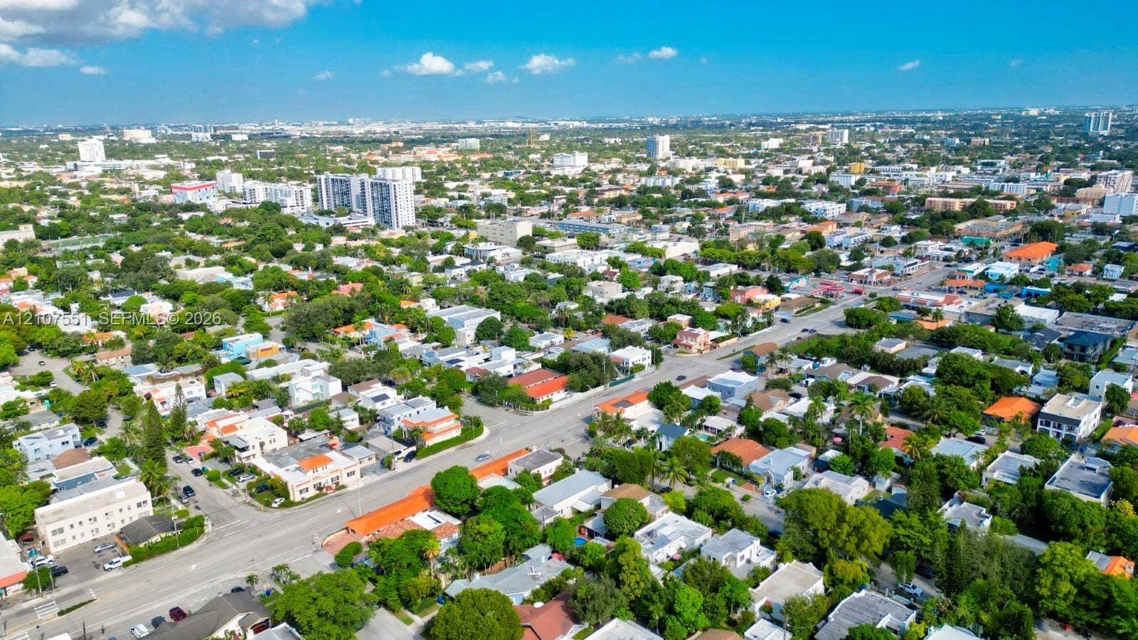 1676 SW 11th Street, Miami, Miami, FL 33135 Aerial perspective of a dense urban neighborhood featuring established tree canopy, grid-pattern street layout, mid-rise residential buildings, and proximity to expansive metropolitan infrastructure