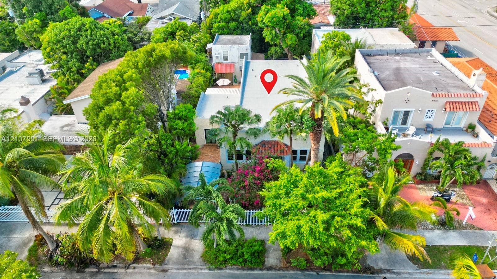1676 SW 11th Street, Miami, Miami, FL 33135 Aerial perspective of a detached residence featuring a pitched roof, terracotta-tiled accents, mature palm trees, and established landscaping