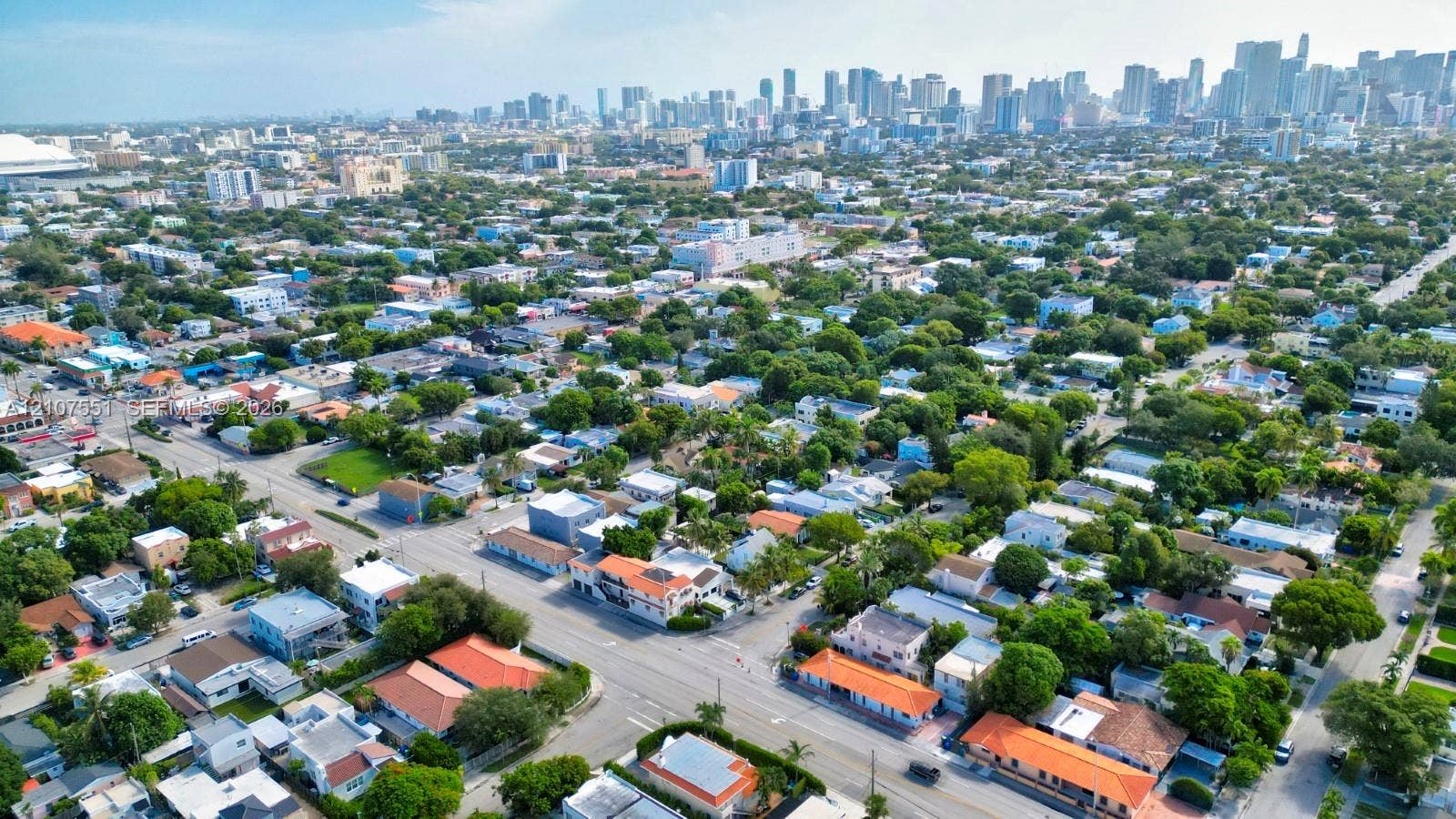 1676 SW 11th Street, Miami, Miami, FL 33135 Aerial perspective featuring an established neighborhood with mature canopy trees and a backdrop of the urban skyline