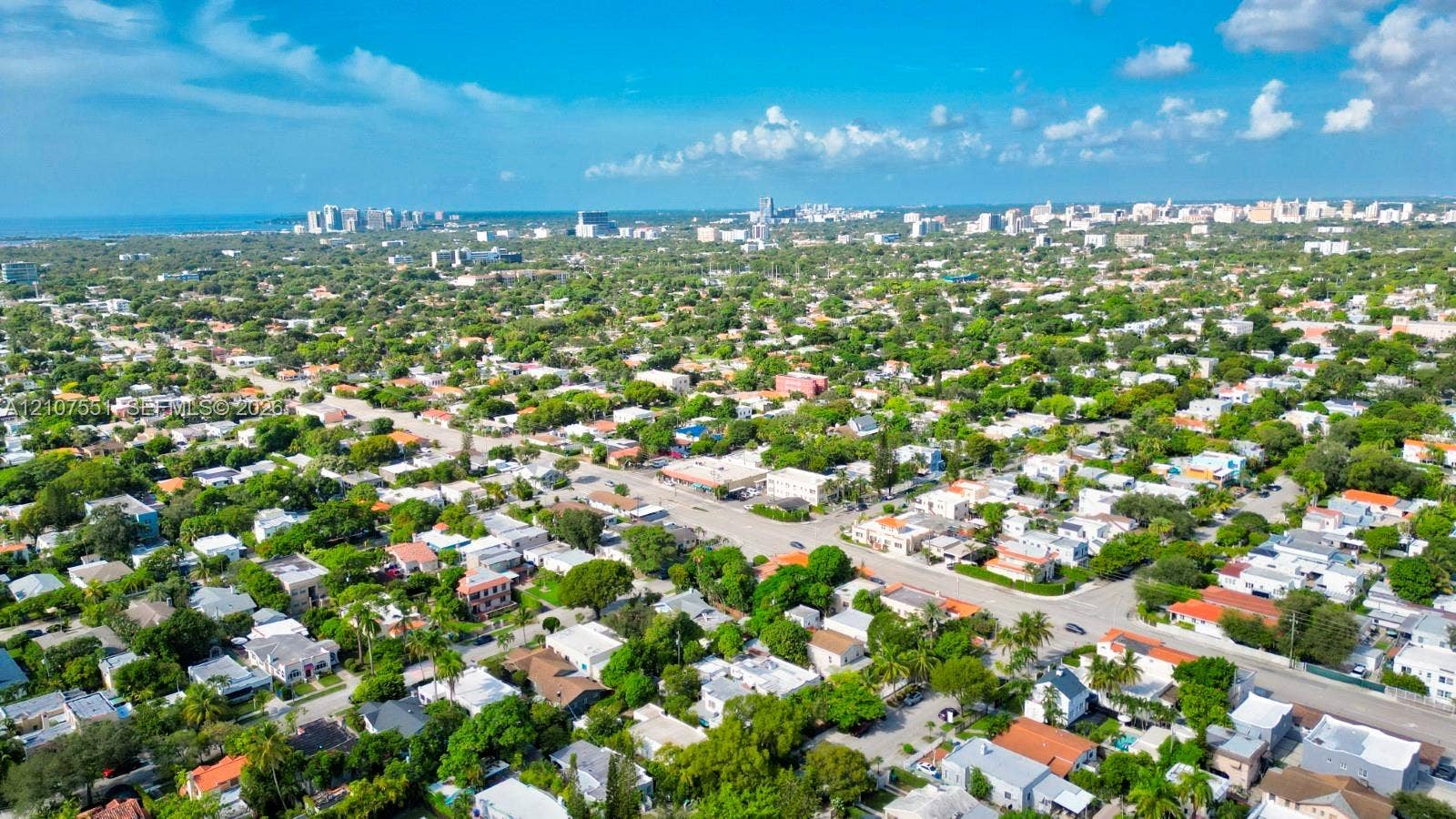 1676 SW 11th Street, Miami, Miami, FL 33135 Aerial perspective featuring dense canopy coverage, established residential street grids, and a coastal horizon