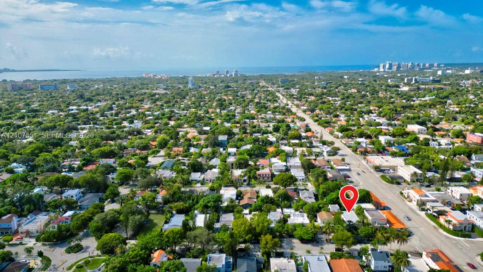 1676 SW 11th Street, Miami, Miami, FL 33135 Aerial perspective of the property featuring dense mature tree coverage, proximity to regional thoroughfares, and a coastal landscape setting