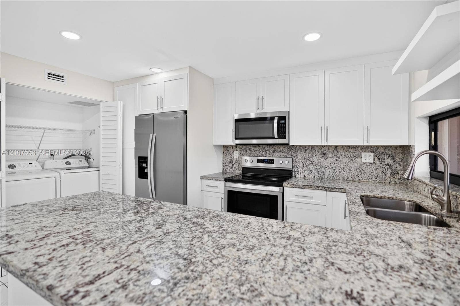 7336 SW 26th Court, #51, Davie, Davie, FL 33314 Kitchen featuring white shaker-style cabinetry, natural stone countertops, recessed lighting, stainless steel appliances, and a dual-basin undermount sink