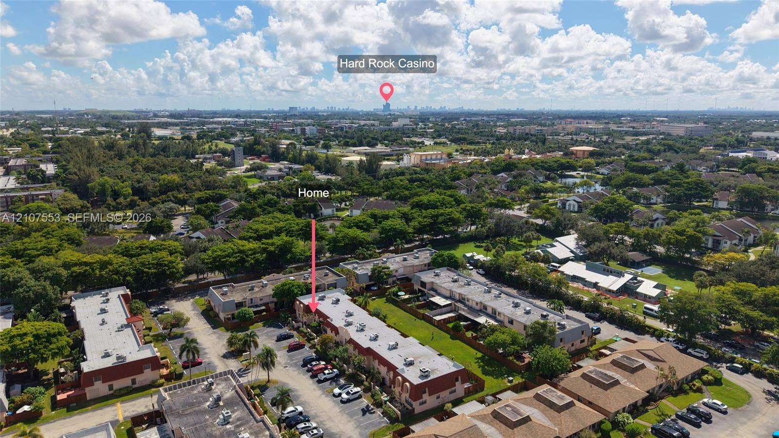 7336 SW 26th Court, #51, Davie, Davie, FL 33314 Aerial perspective of multi-family property featuring multi-story residential structures, paved parking areas, and abundant mature landscaping