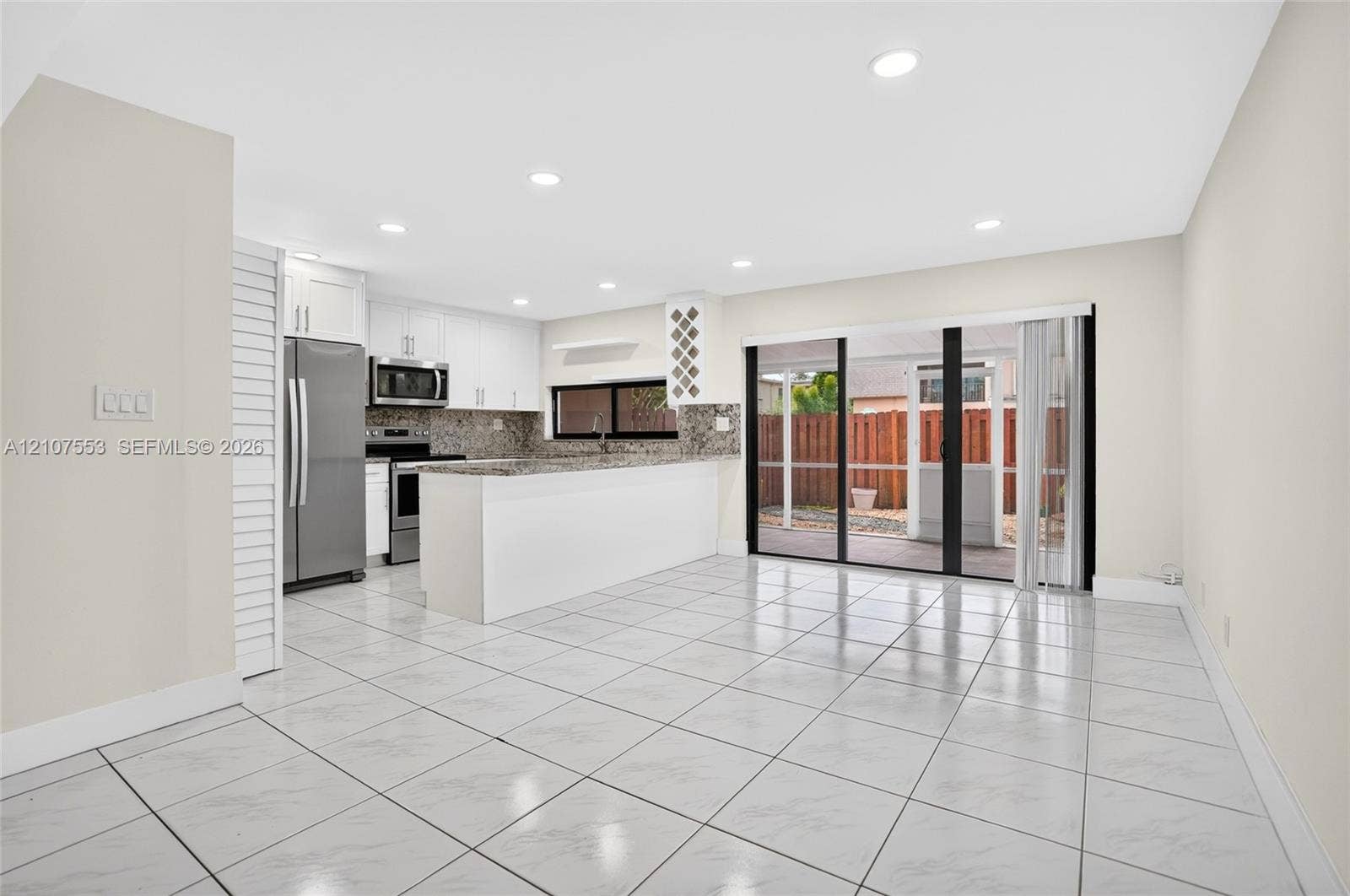 7336 SW 26th Court, #51, Davie, Davie, FL 33314 Kitchen featuring white cabinetry, stone-surface countertops, stainless steel appliances, recessed lighting, and tile flooring