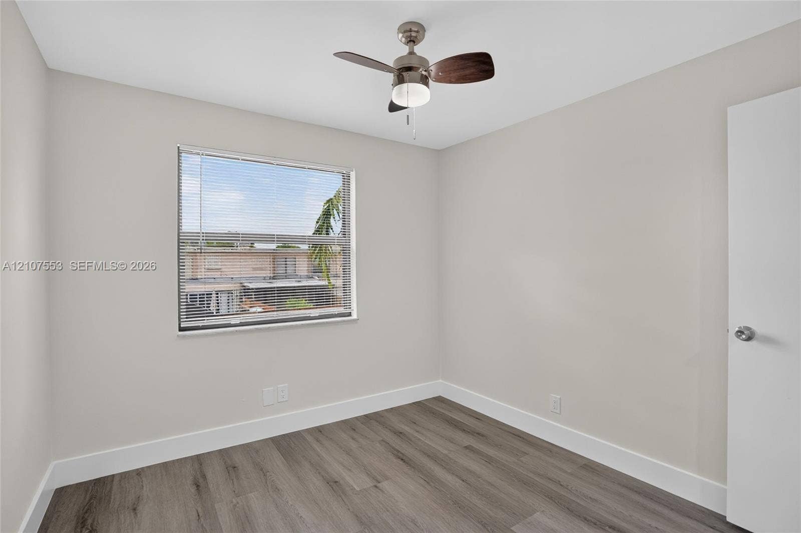 7336 SW 26th Court, #51, Davie, Davie, FL 33314 Neutral wall finishes, wood-finish flooring, and a ceiling fan with integrated lighting