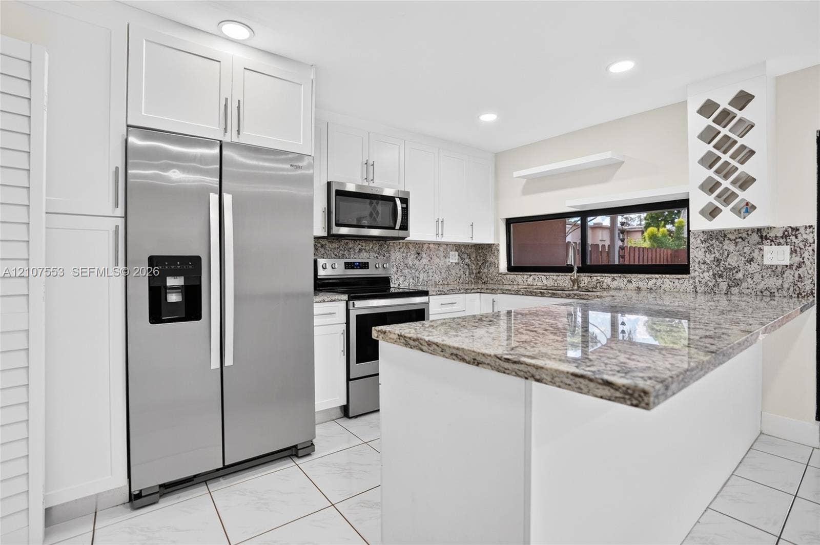 7336 SW 26th Court, #51, Davie, Davie, FL 33314 Kitchen featuring white cabinetry, stone-surface countertops, stainless steel appliances, a built-in wine rack, and tile flooring