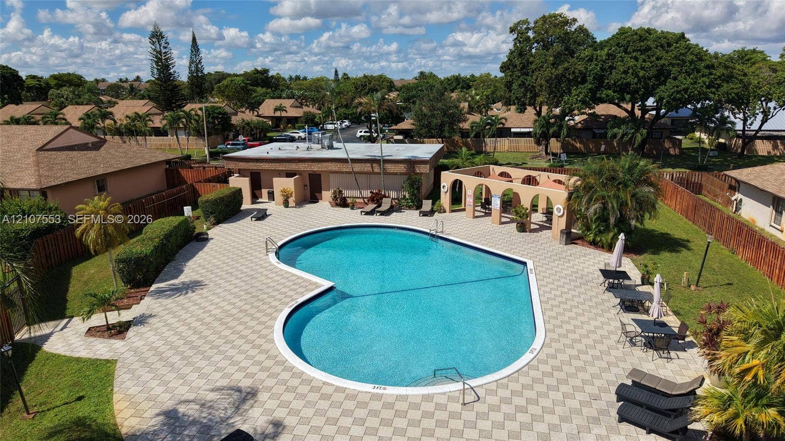 7336 SW 26th Court, #51, Davie, Davie, FL 33314 Community pool featuring an expansive paved deck, covered seating pavilion with arched masonry, and manicured green space