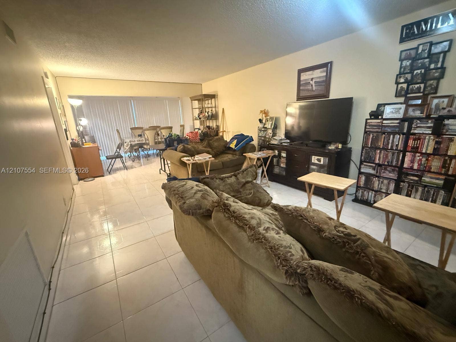 Open floor plan featuring large format tile flooring and floor-to-ceiling sliding glass doors