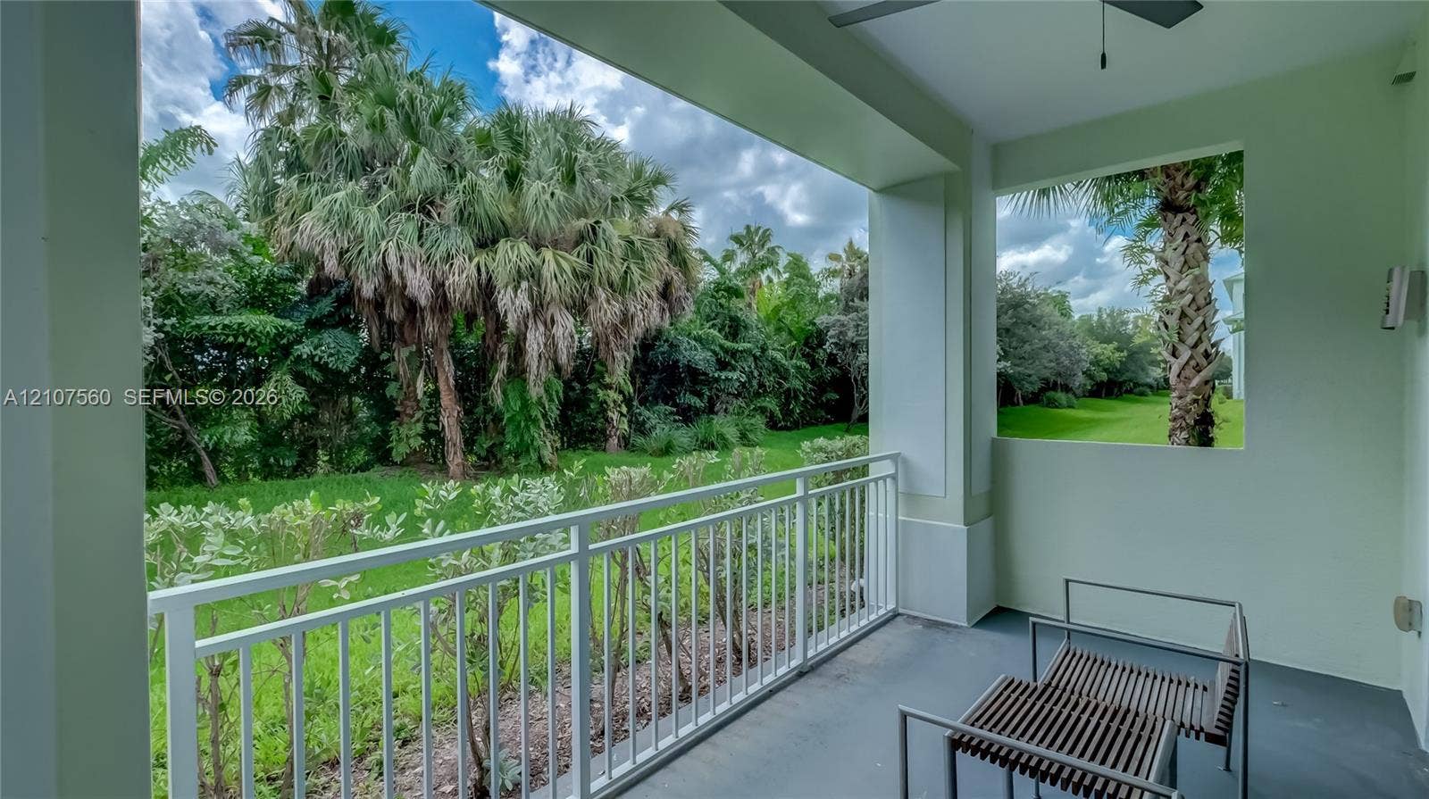 5300 NW 87th Avenue, #407, Doral, FL 33178 Covered balcony featuring white metal railings, concrete flooring, and an integrated ceiling fan