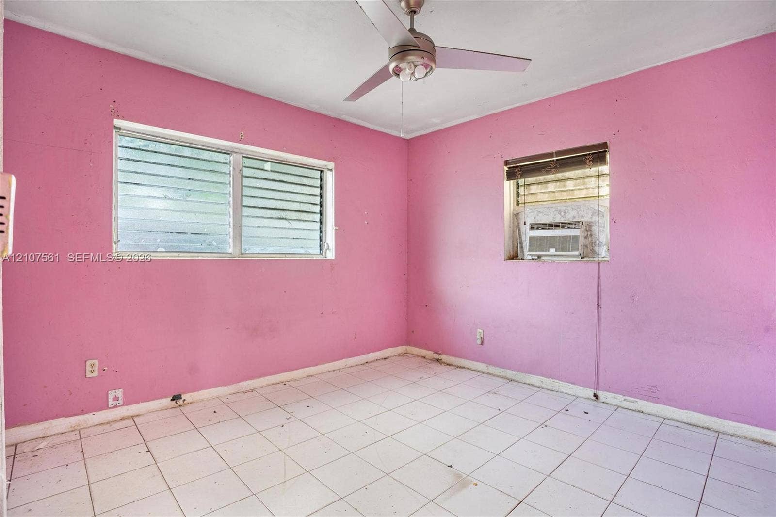 50 NW 69th Street, Miami, FL 33150 Room featuring square ceramic tile flooring, a multi-blade ceiling fan, and horizontal louvered windows