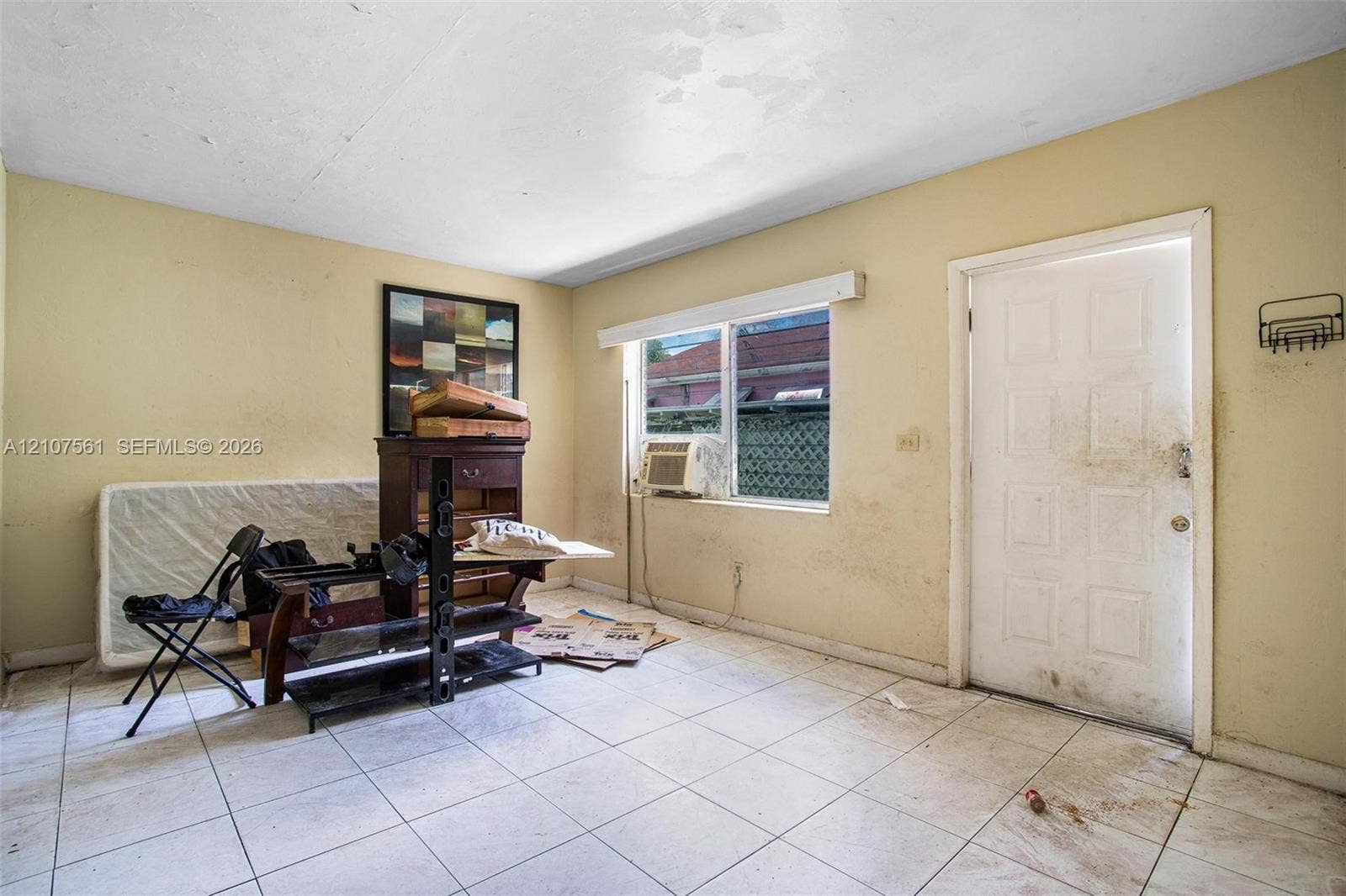 50 NW 69th Street, Miami, FL 33150 Interior space featuring white square tile flooring and a multi-panel exterior door
