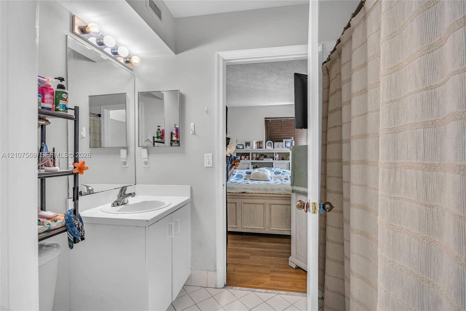 3765 San Simeon Circle, #3765, Weston, Weston, FL 33331 Bathroom featuring a white vanity cabinet, integrated sink with a chrome faucet, large wall-mounted mirror, and tile flooring