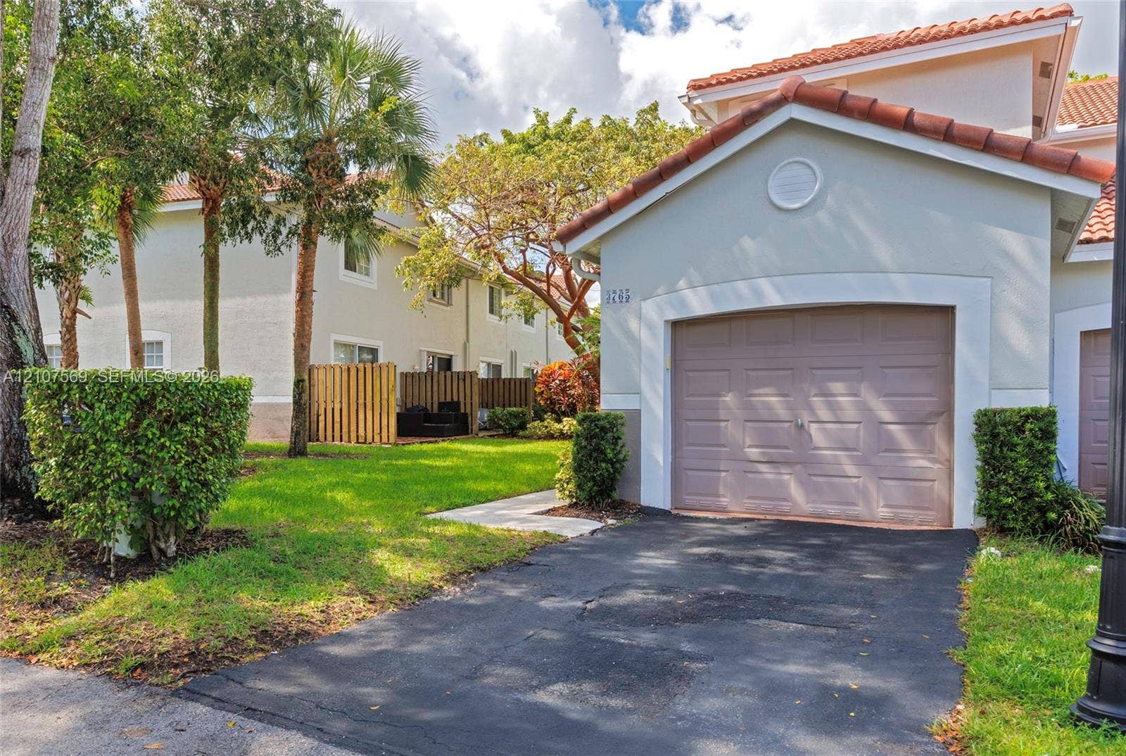 3765 San Simeon Circle, #3765, Weston, Weston, FL 33331 Stucco exterior featuring a tiled roof and single-car garage with asphalt driveway