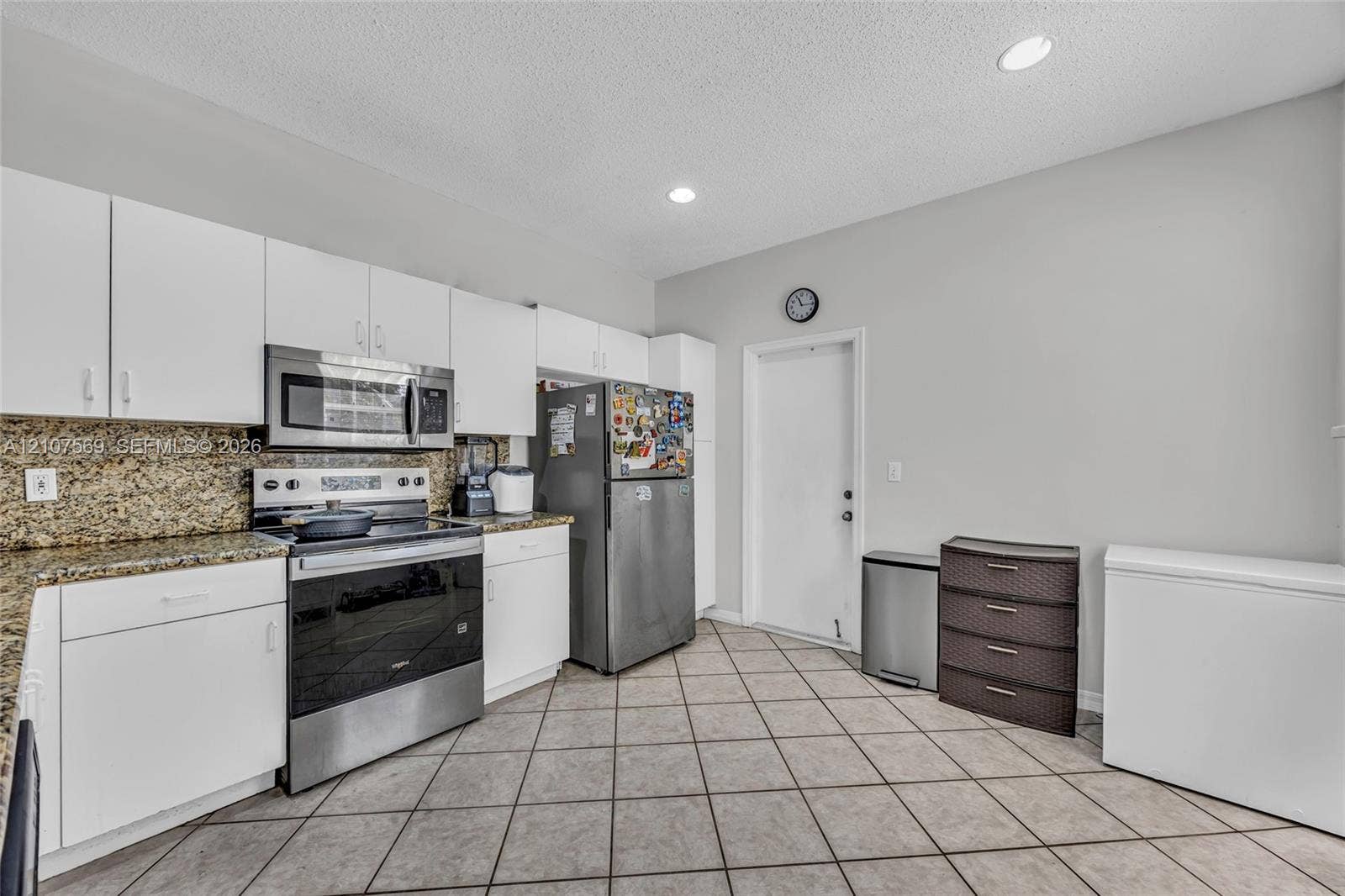 3765 San Simeon Circle, #3765, Weston, Weston, FL 33331 Kitchen featuring white cabinetry, stone countertops, stainless steel appliances, and ceramic tile flooring