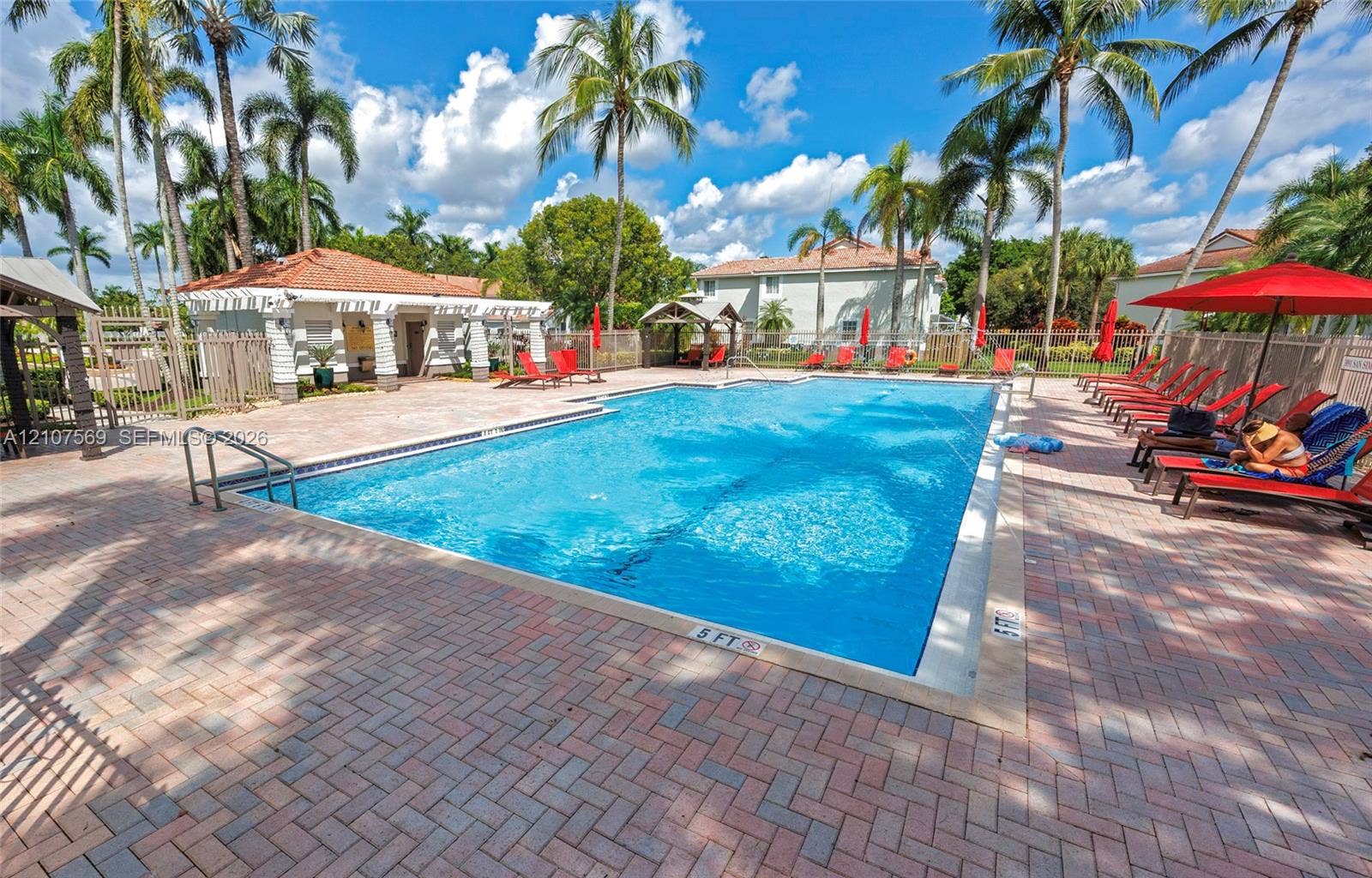 3765 San Simeon Circle, #3765, Weston, Weston, FL 33331 Rectangular swimming pool featuring brick paver decking, a covered poolside pavilion, and mature palm trees