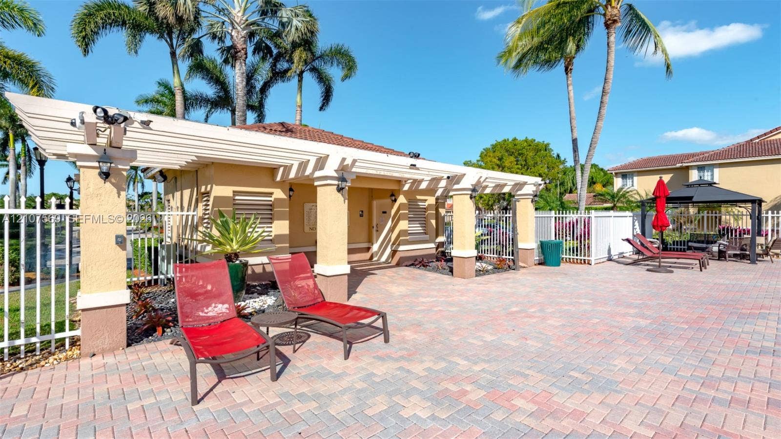 3765 San Simeon Circle, #3765, Weston, Weston, FL 33331 Outdoor pavilion featuring a white pergola, textured stucco columns, paver patio, and white metal fencing