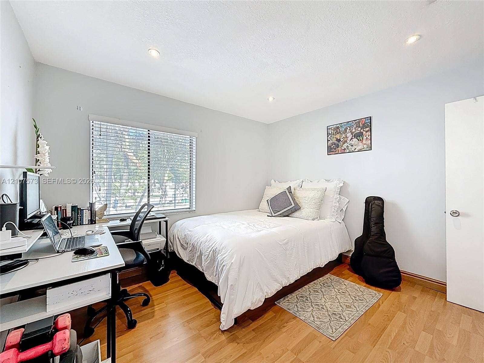 1291 SW 124th Court, #19-B, Miami, FL 33184 Room featuring wood-finish flooring, recessed lighting, and a window with horizontal blinds