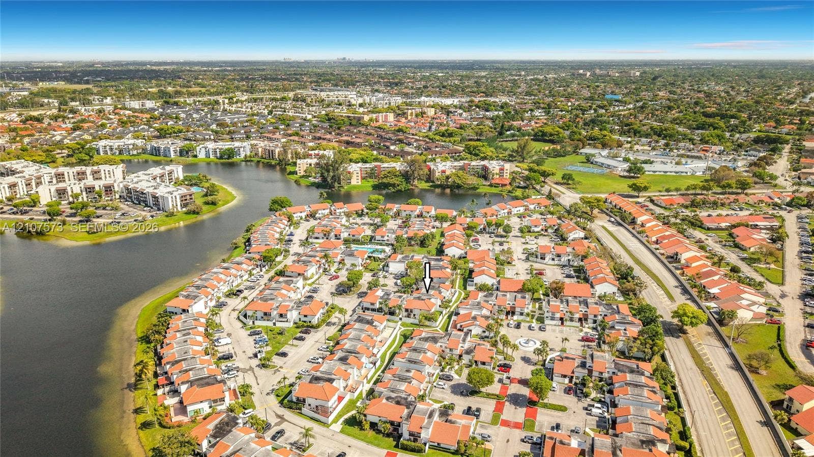 1291 SW 124th Court, #19-B, Miami, FL 33184 Aerial perspective of residential community featuring multi-unit structures with terracotta-style roofs and mature landscaping