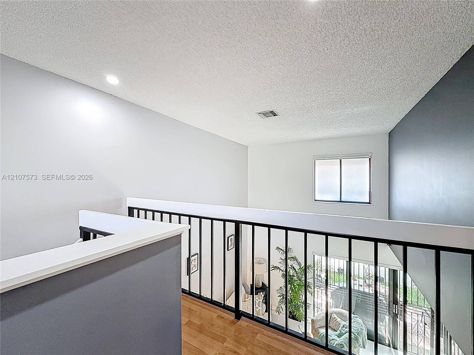 1291 SW 124th Court, #19-B, Miami, FL 33184 Interior balcony featuring wood-finish flooring, matte black metal railings, recessed lighting, and high ceilings