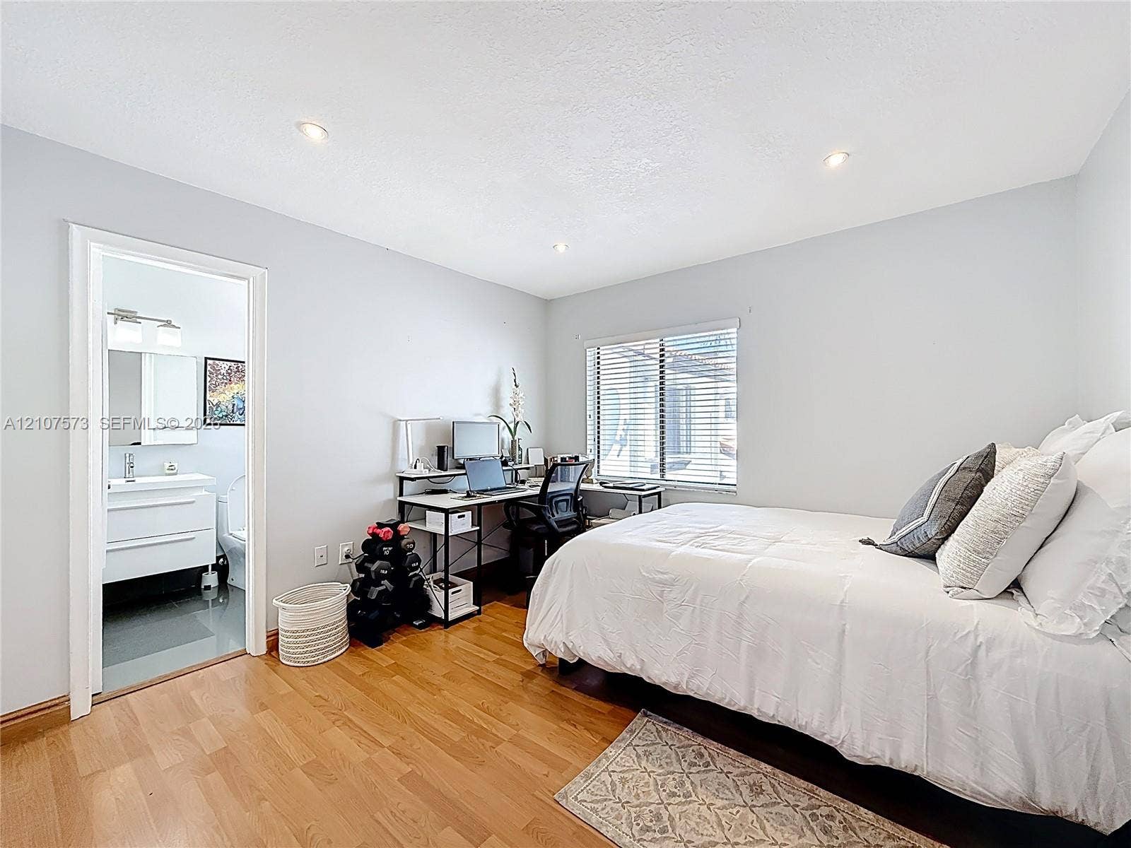 1291 SW 124th Court, #19-B, Miami, FL 33184 Room featuring wood-finish flooring, recessed lighting, and a window with horizontal blinds