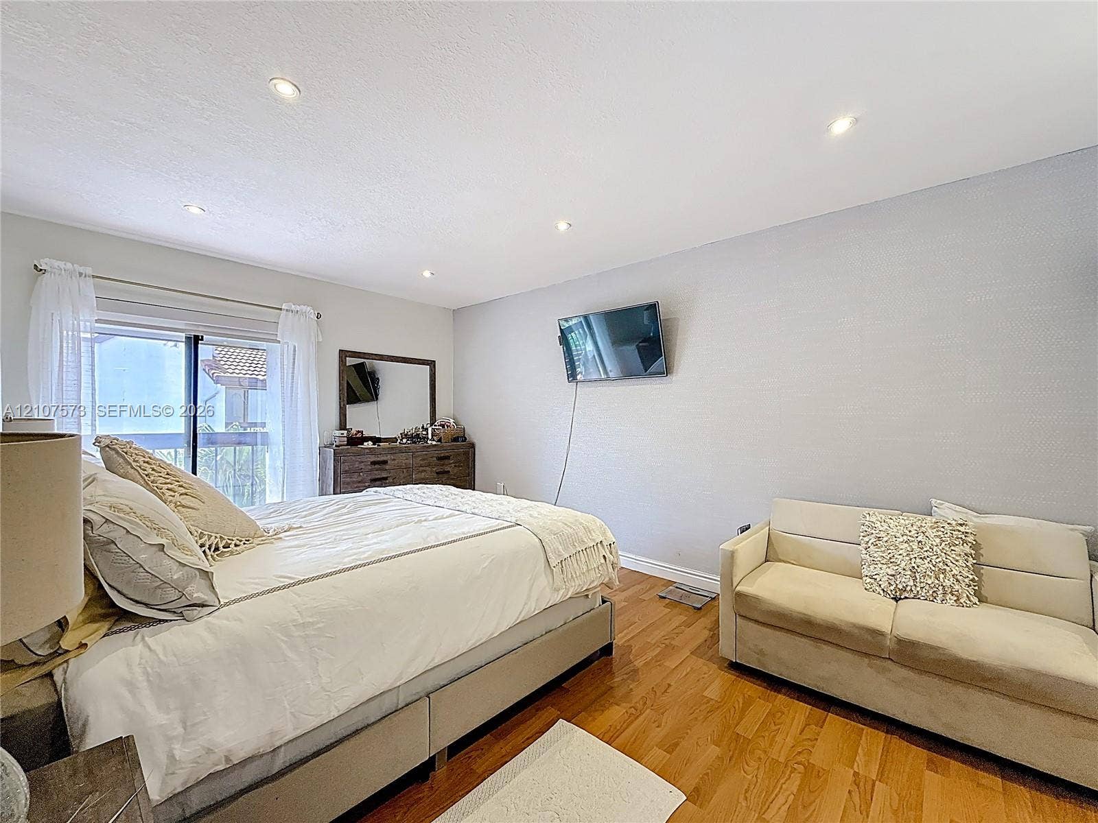 1291 SW 124th Court, #19-B, Miami, FL 33184 Wood-finish flooring, recessed ceiling lighting, and sliding glass doors with exterior access