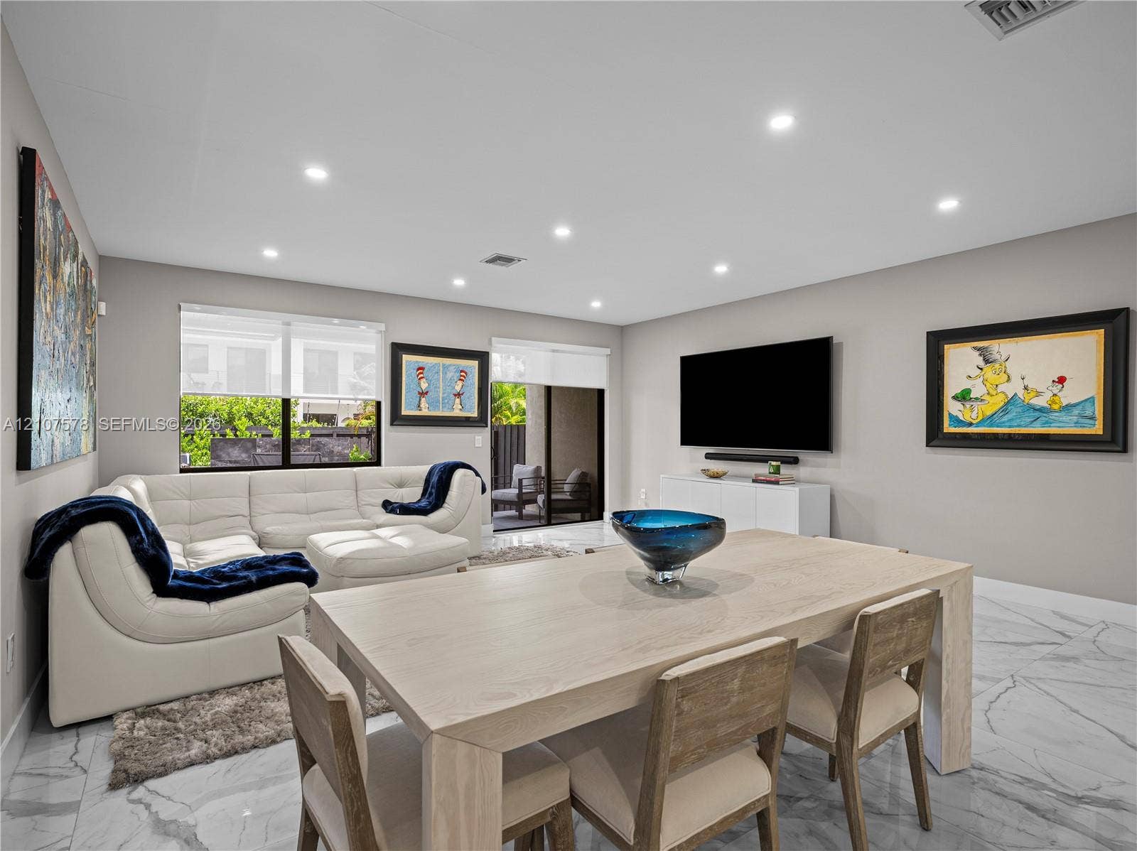 307 SW 10th Street, Fort Lauderdale, FL 33315 Open-concept interior featuring large-format tile flooring, recessed ceiling lighting, and sliding glass doors