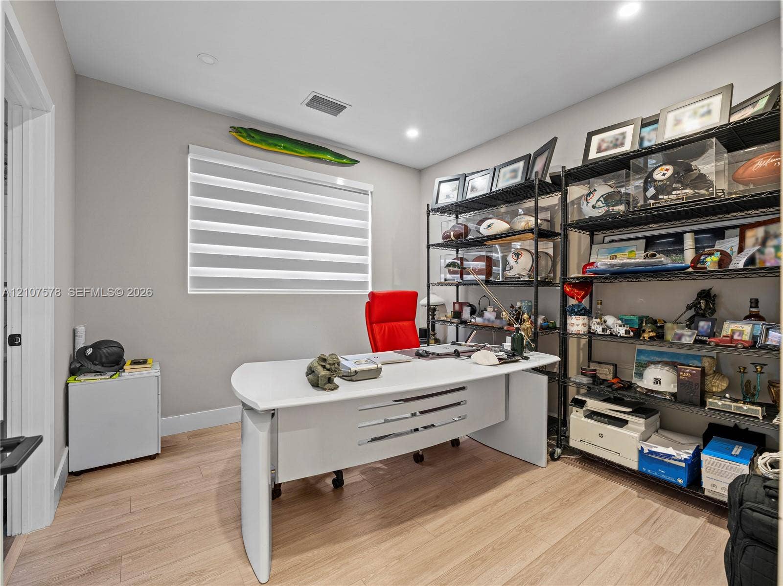 307 SW 10th Street, Fort Lauderdale, FL 33315 Neutral wall finishes, wood-finish flooring, and horizontal window shades