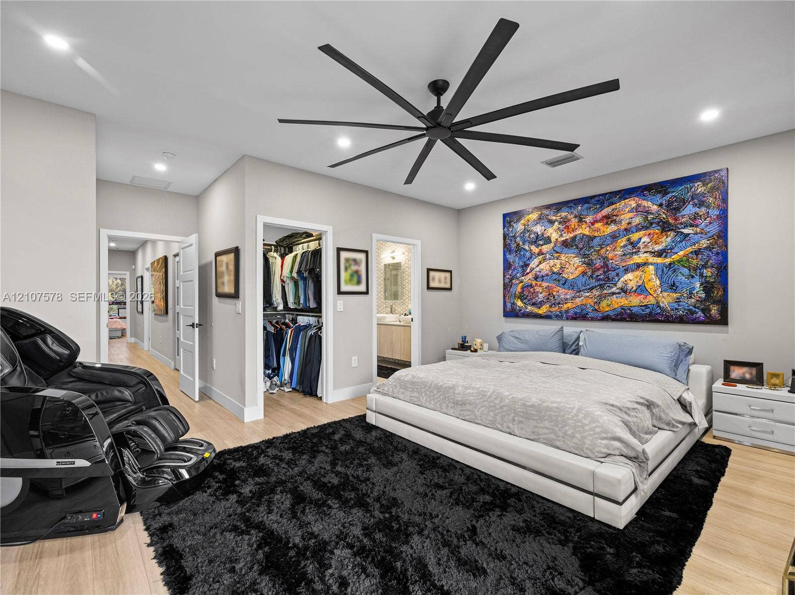 307 SW 10th Street, Fort Lauderdale, FL 33315 Light-toned wood-finish flooring, recessed lighting, multi-blade matte black ceiling fan, and walk-in closet with built-in storage