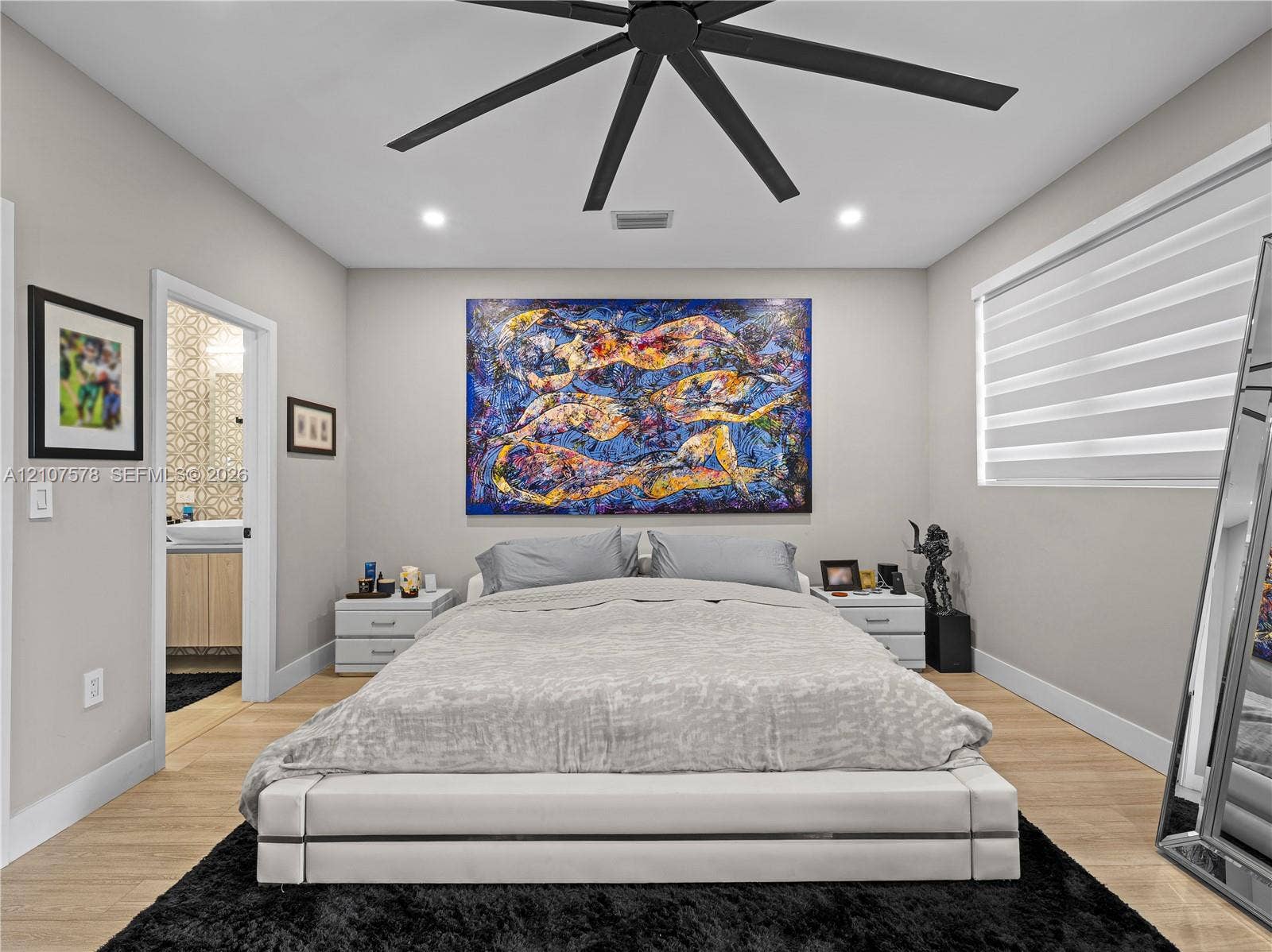 307 SW 10th Street, Fort Lauderdale, FL 33315 Neutral-toned interior featuring wood-finish flooring, a contemporary multi-blade ceiling fan, recessed lighting, and adjustable horizontal window blinds