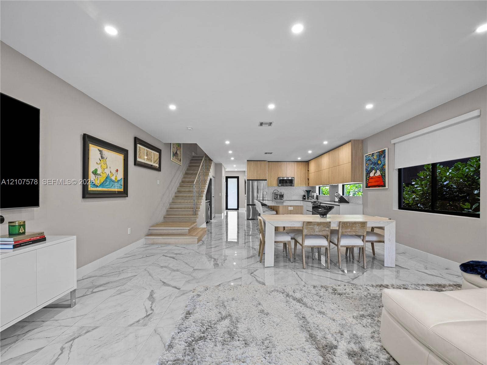 307 SW 10th Street, Fort Lauderdale, FL 33315 Large-format stone-finish tile flooring, recessed ceiling lighting, wood-finish flat-panel cabinetry, and staircase with metal cable railing