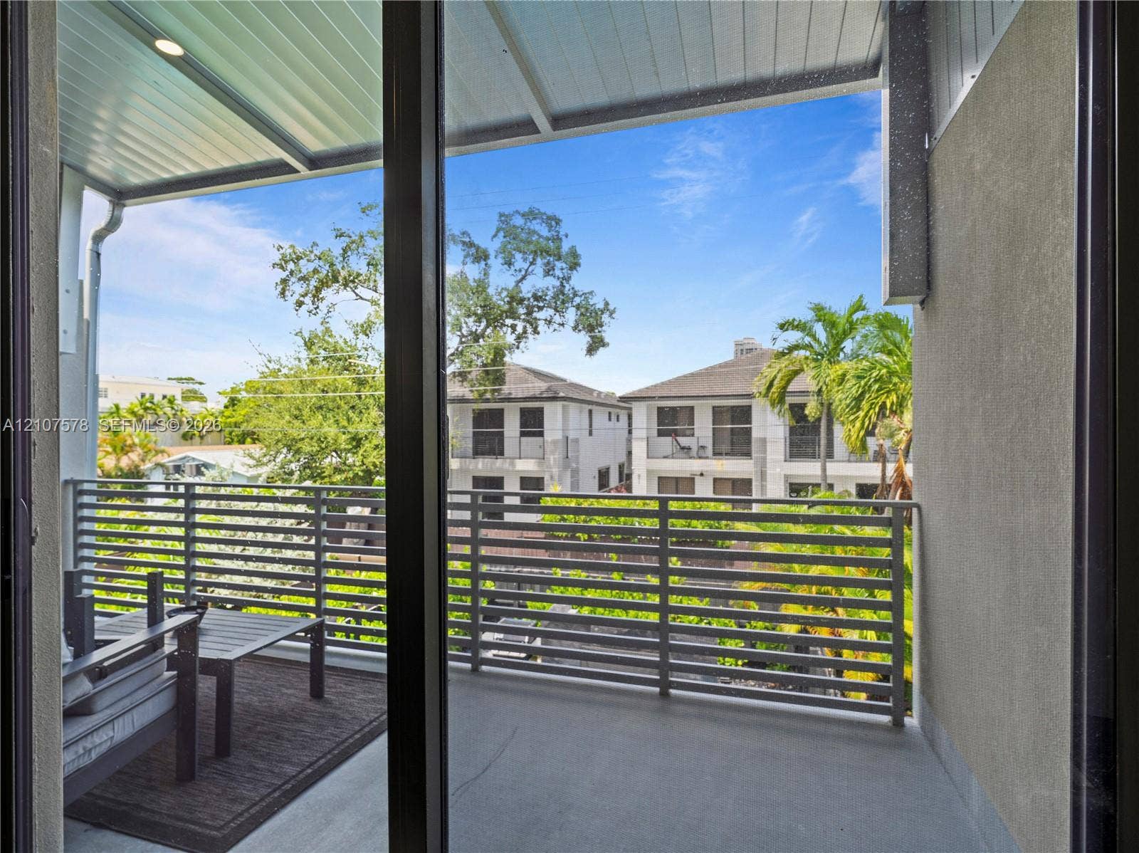 307 SW 10th Street, Fort Lauderdale, FL 33315 Covered balcony featuring a metal horizontal-slat railing, concrete flooring, and a recessed ceiling light