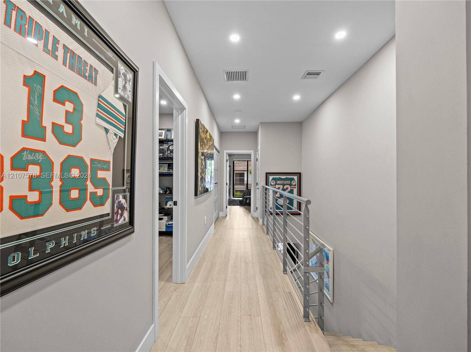 307 SW 10th Street, Fort Lauderdale, FL 33315 Hallway featuring light-toned wood-finish flooring, recessed ceiling lighting, and a metal horizontal-bar railing