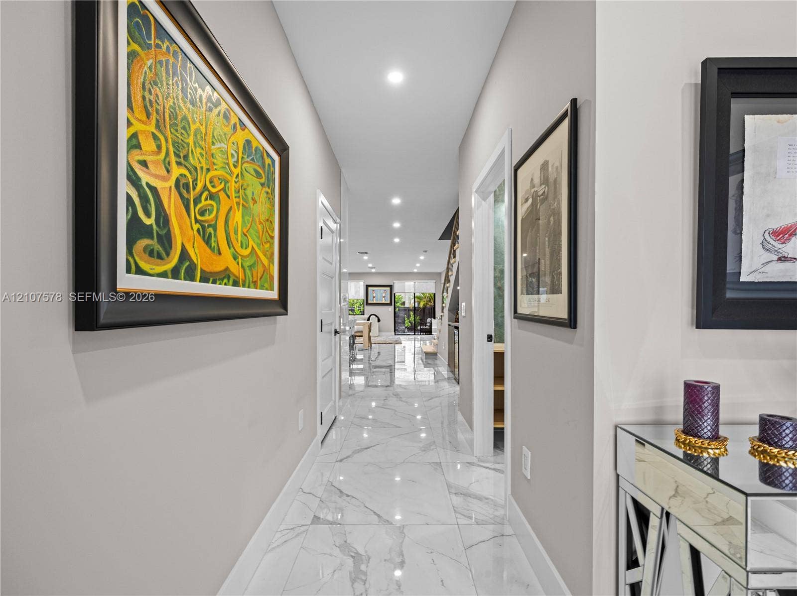307 SW 10th Street, Fort Lauderdale, FL 33315 Neutral-toned interior hallway featuring large-format stone-finish tile flooring, recessed ceiling lighting, and multi-panel interior doors