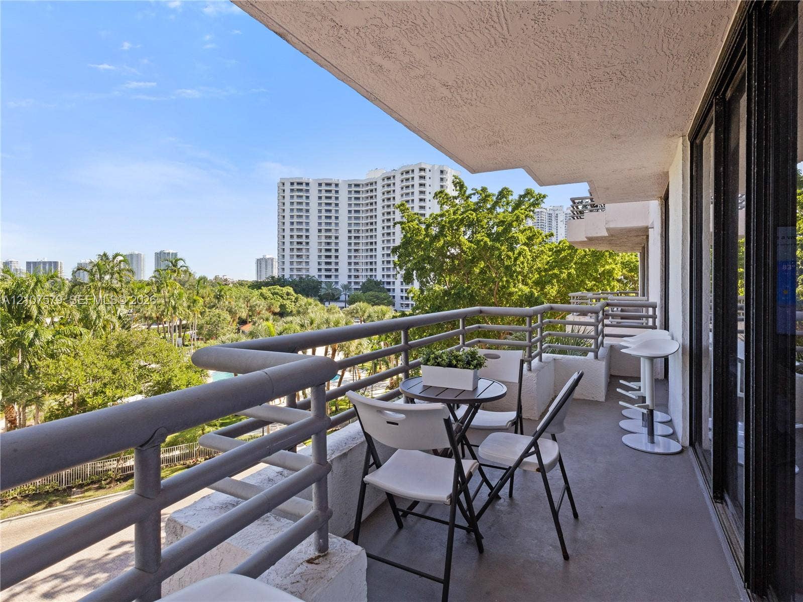 3300 NE 191st Street, #511, Aventura, FL 33180 Covered balcony with grey concrete flooring and horizontal metal railing