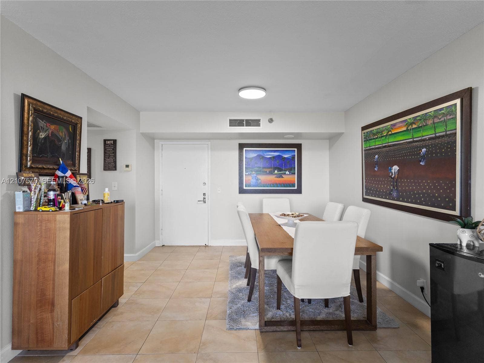 3300 NE 191st Street, #511, Aventura, FL 33180 Neutral-toned interior space featuring light-colored ceramic tile flooring, a flush-mount ceiling light fixture, and a solid-core entry door