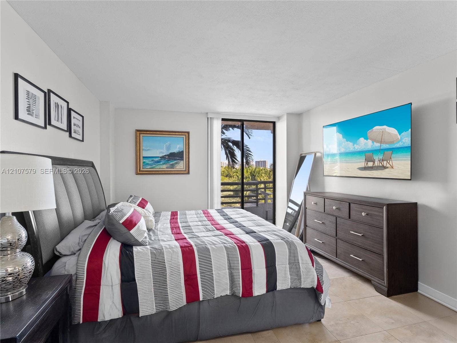 3300 NE 191st Street, #511, Aventura, FL 33180 Neutral wall tones, tile flooring, and glass sliding doors providing access to a private balcony