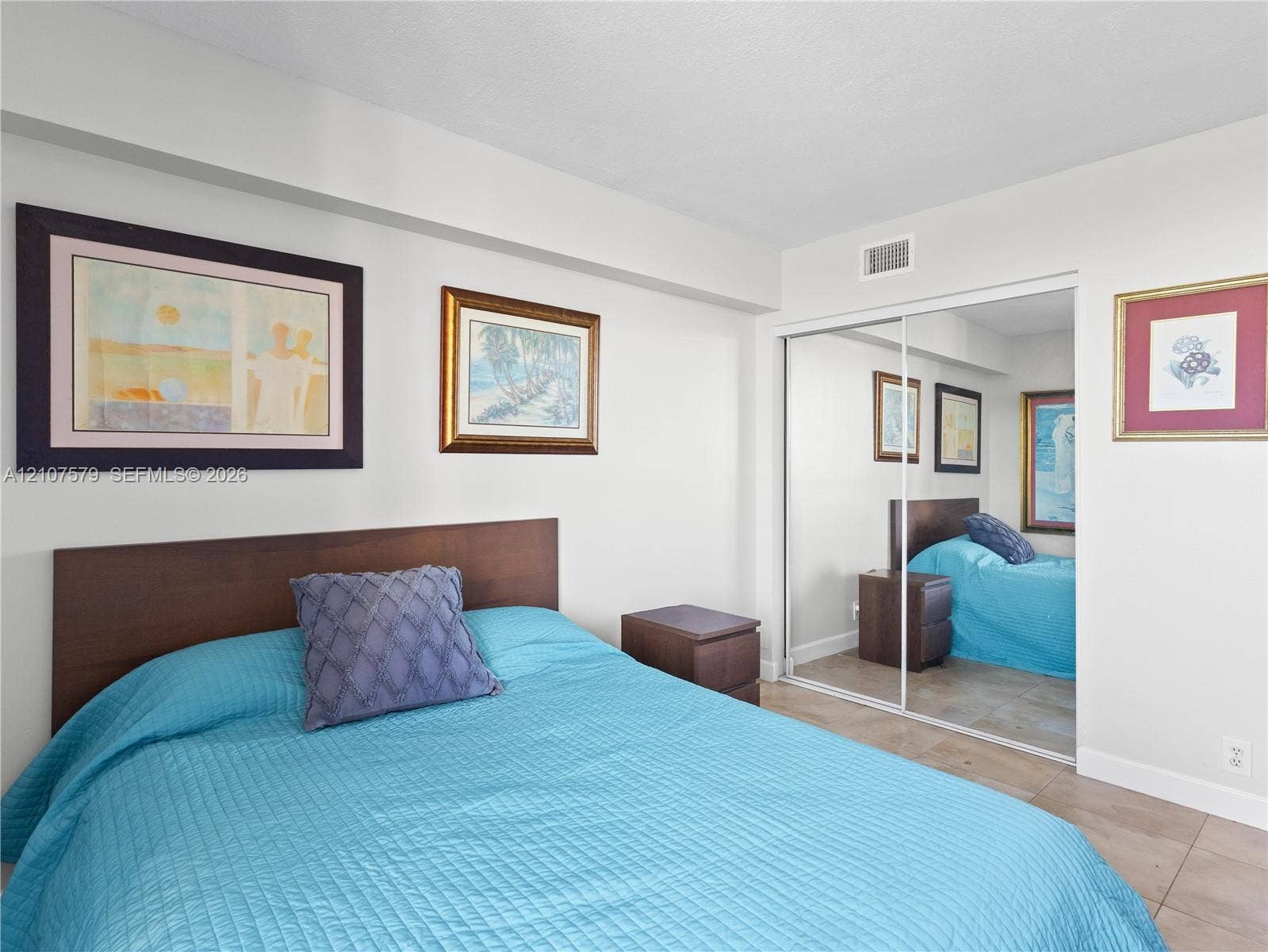 3300 NE 191st Street, #511, Aventura, FL 33180 Floor-to-ceiling mirrored sliding closet doors and tile flooring