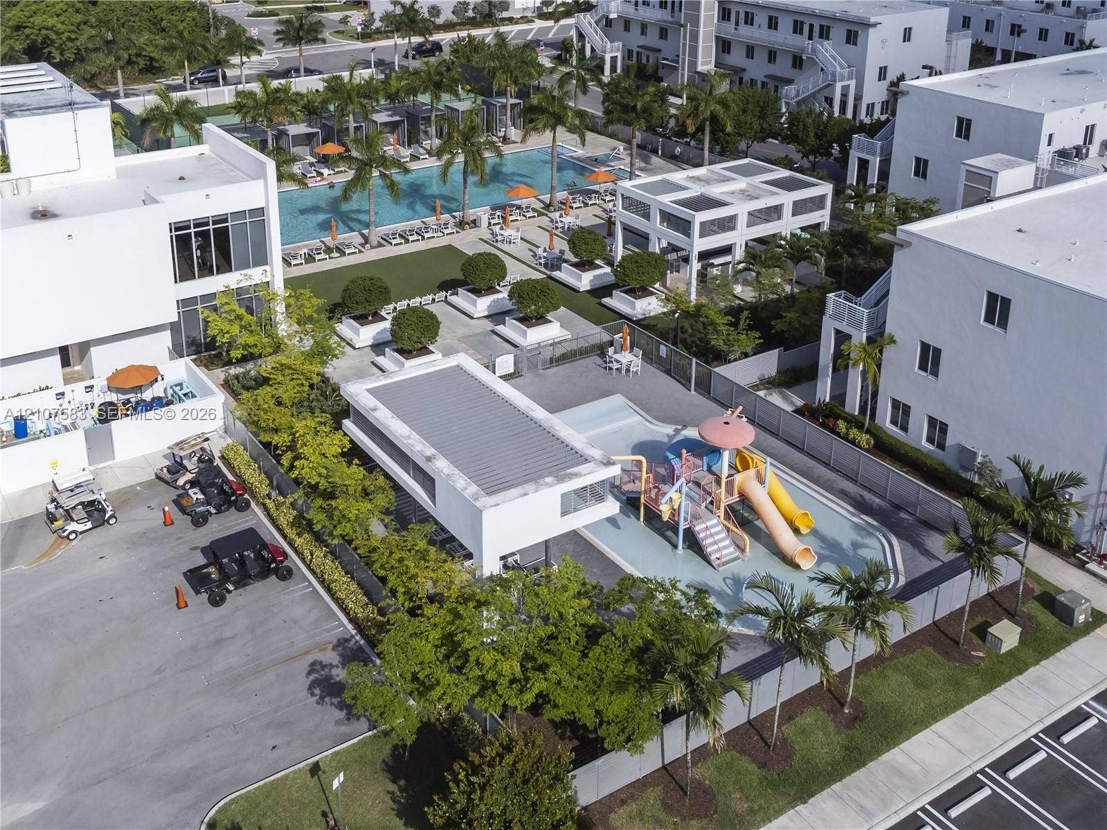 10270 NW 66th Street, #110, Doral, Doral, FL 33178 Community amenities featuring a swimming pool, covered pavilion, splash park with slides, and manicured landscaping