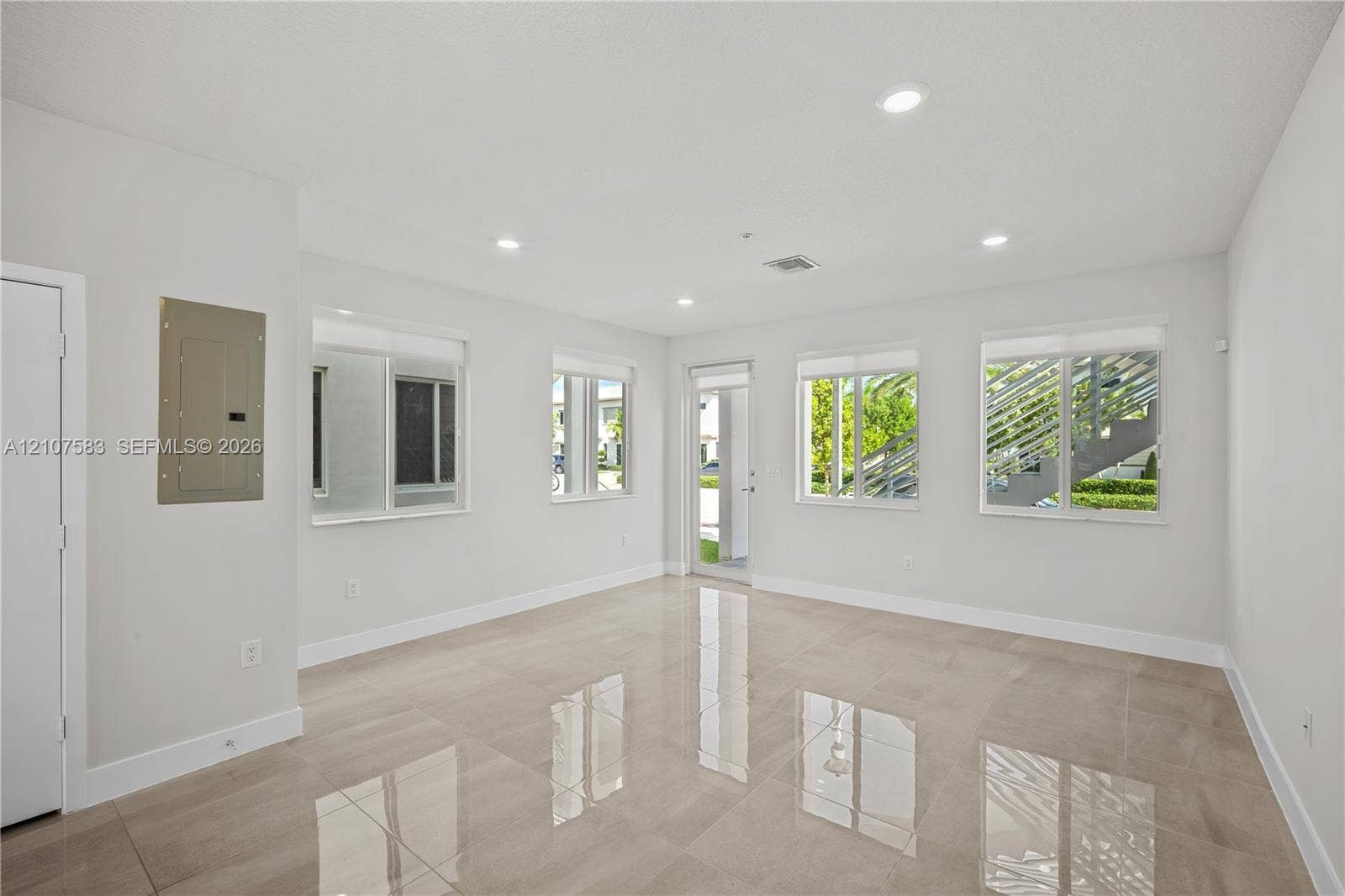 10270 NW 66th Street, #110, Doral, Doral, FL 33178 Neutral-toned interior featuring large-format tile flooring, recessed ceiling lighting, and multiple windows providing natural light