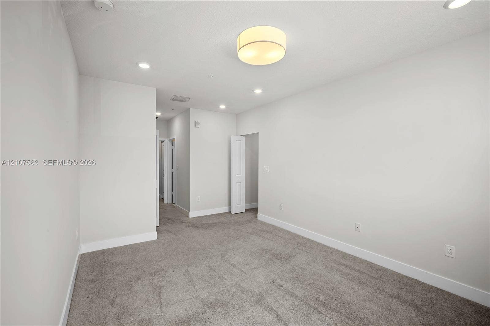 10270 NW 66th Street, #110, Doral, Doral, FL 33178 Interior space featuring neutral wall tones, plush carpeting, a central drum-style ceiling light, and recessed lighting