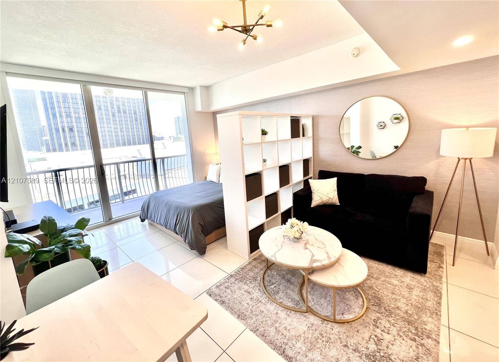 1750 N Bayshore Drive, #1218, Miami, Miami, FL 33132 Floor-to-ceiling glass sliding doors, polished tile flooring, industrial-style multi-arm ceiling lighting, and textured wall finish