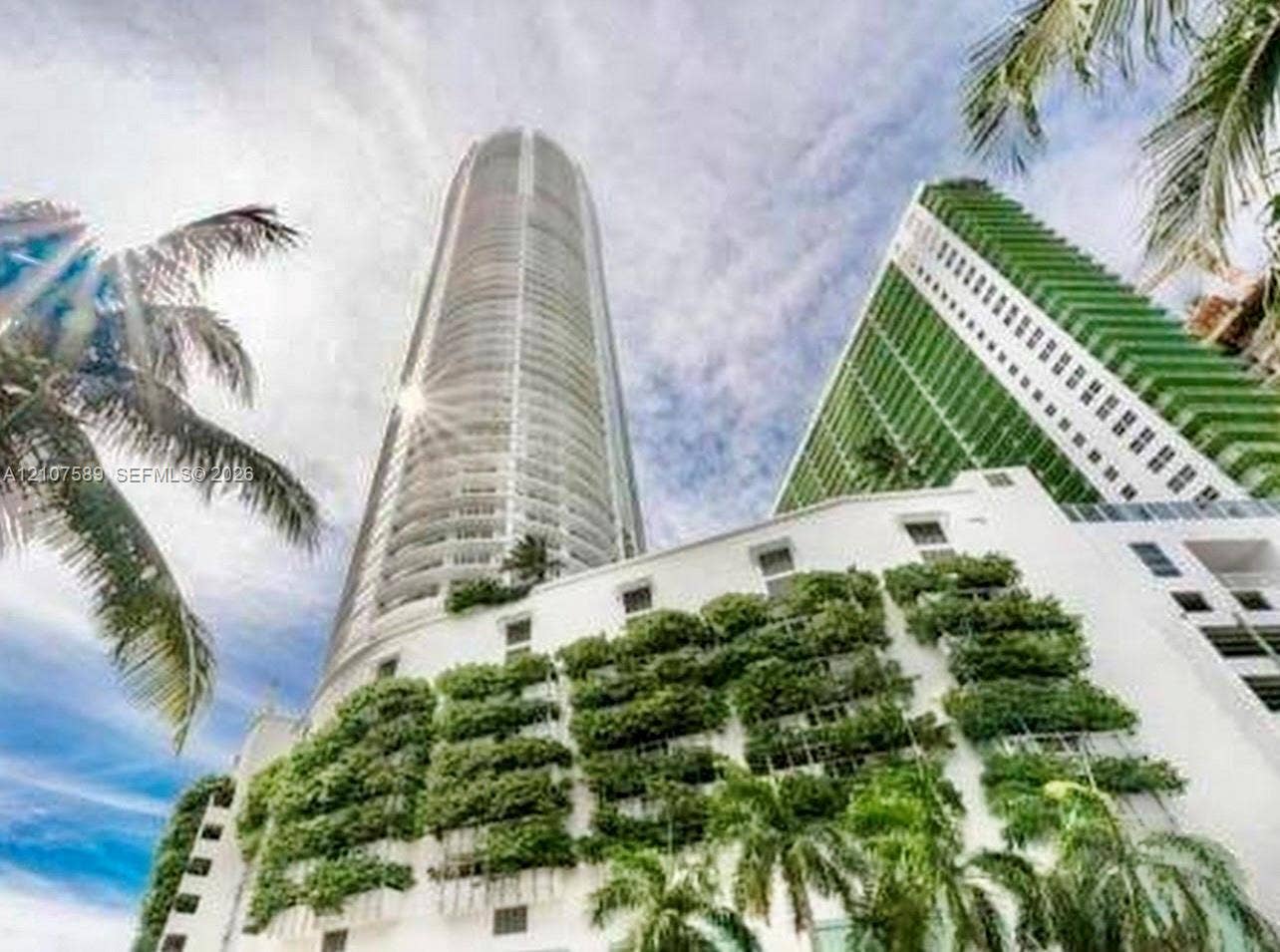 1750 N Bayshore Drive, #1218, Miami, Miami, FL 33132 High-rise architectural structure featuring a cylindrical glass facade, exterior vertical garden greenery, and private wrap-around balconies