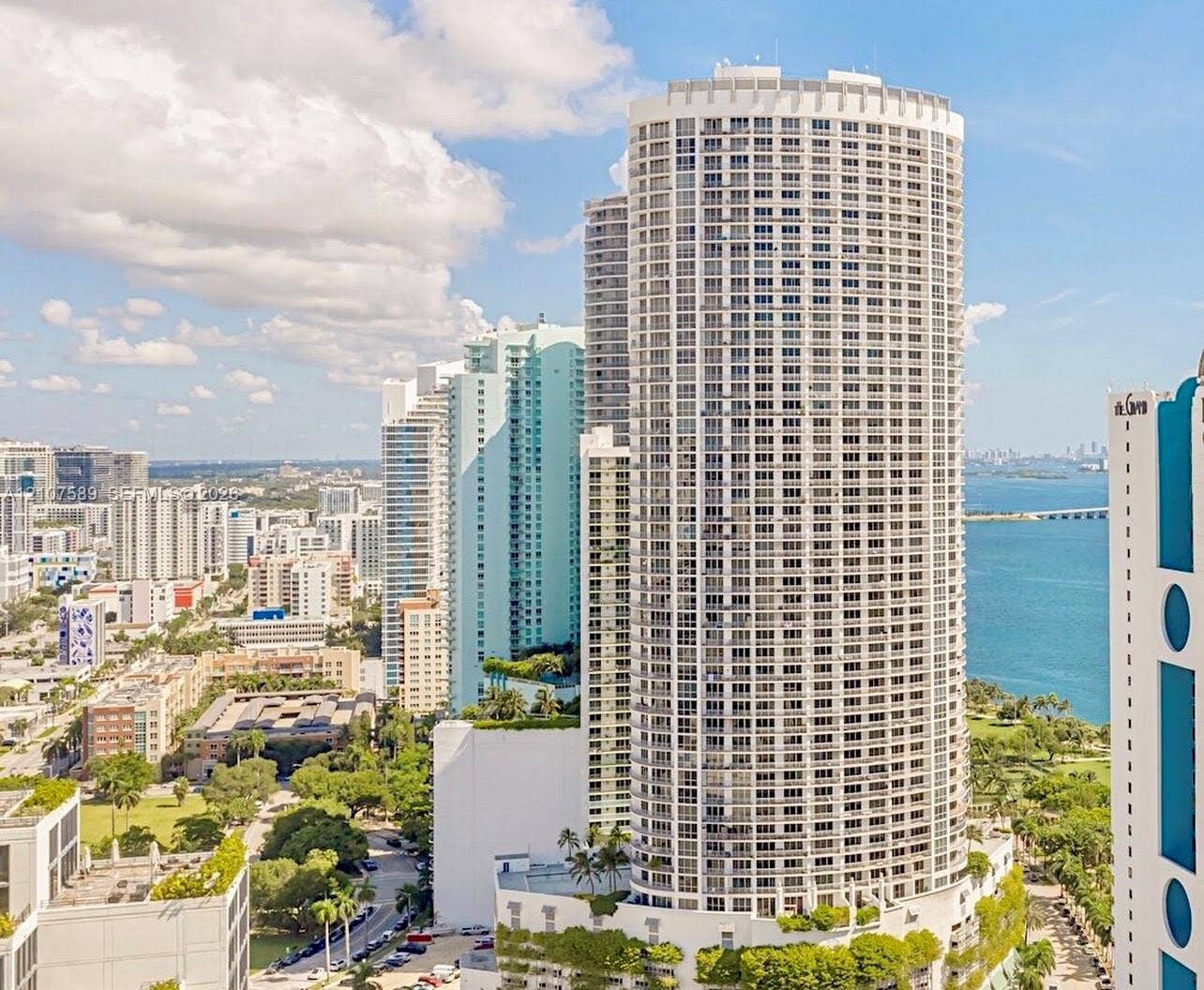 1750 N Bayshore Drive, #1218, Miami, Miami, FL 33132 High-rise residential tower featuring a cylindrical glass-and-concrete facade, private balconies, and an urban waterfront location