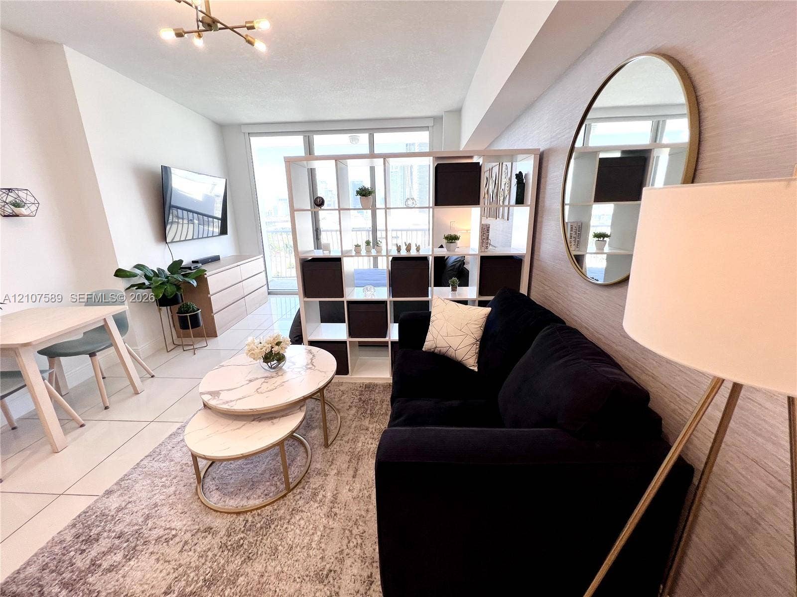 1750 N Bayshore Drive, #1218, Miami, Miami, FL 33132 Open-concept living space featuring large-format tile flooring, textured wallpaper, and floor-to-ceiling glass patio doors