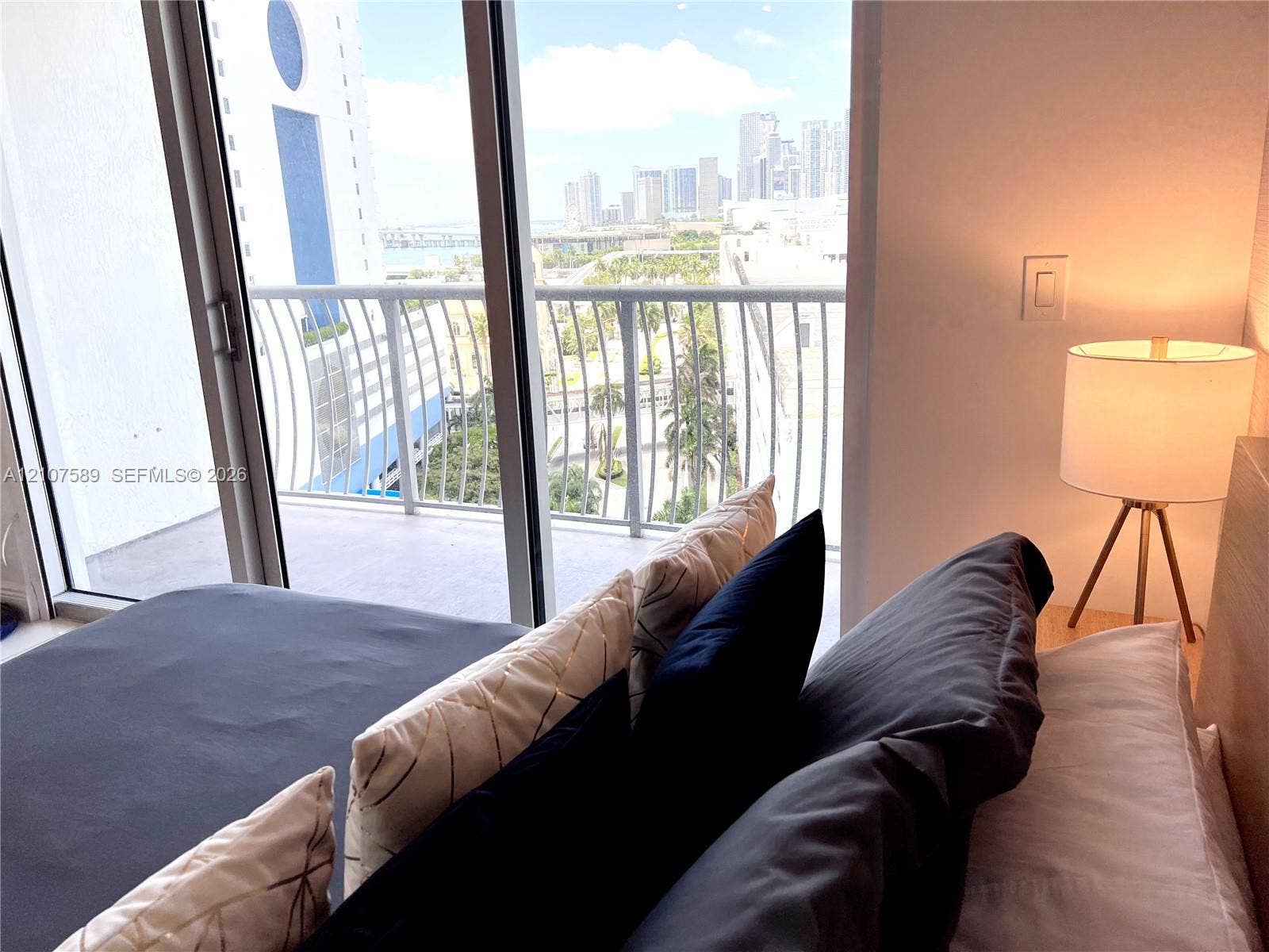 1750 N Bayshore Drive, #1218, Miami, Miami, FL 33132 Floor-to-ceiling sliding glass door providing external access to a private balcony with a metal railing and expansive urban scenery