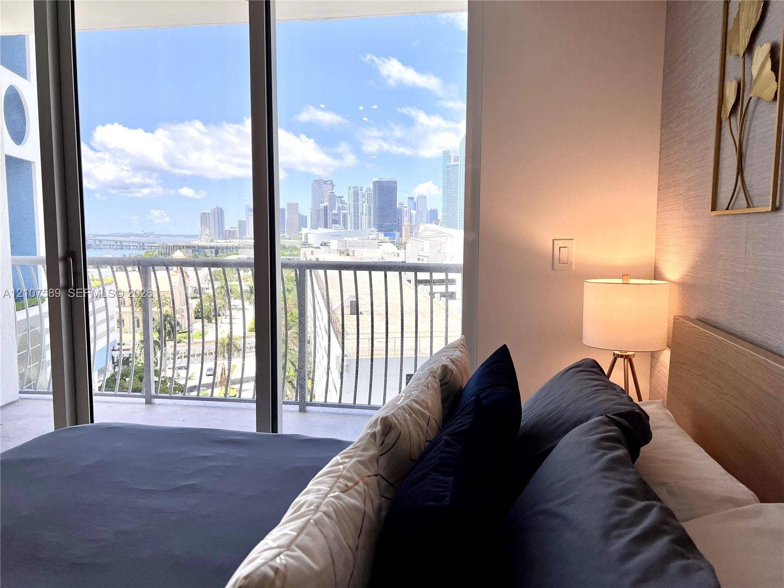 1750 N Bayshore Drive, #1218, Miami, Miami, FL 33132 Floor-to-ceiling sliding glass door, private balcony with metal railing, and textured wall finish